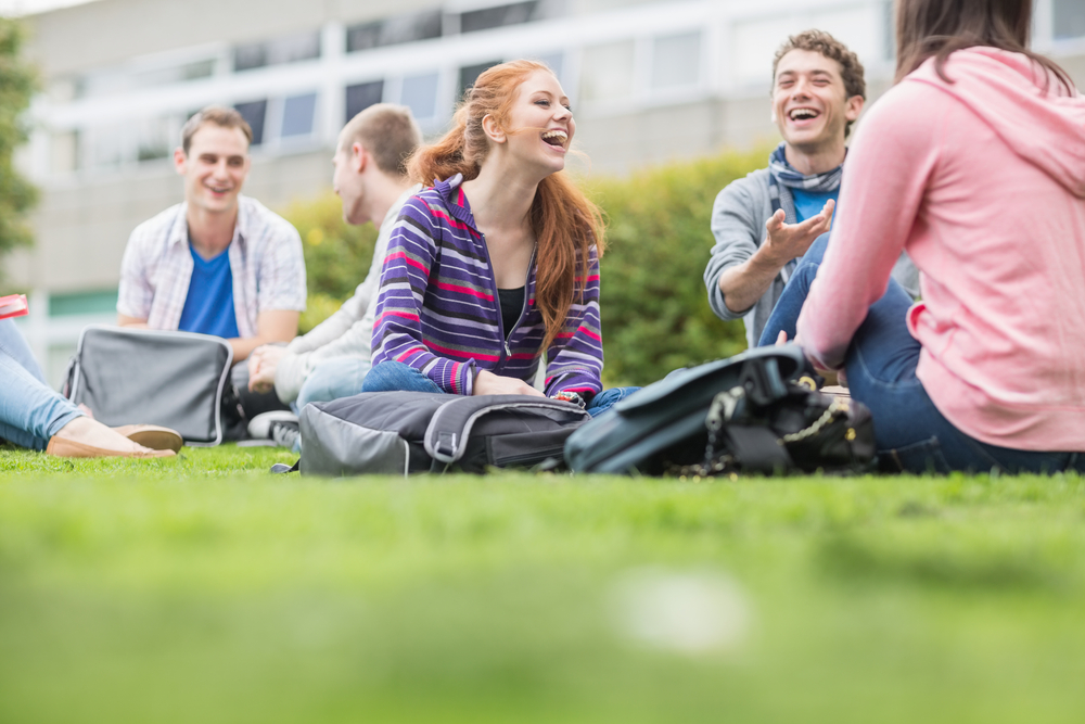 Group of young college students sitting in the park-1